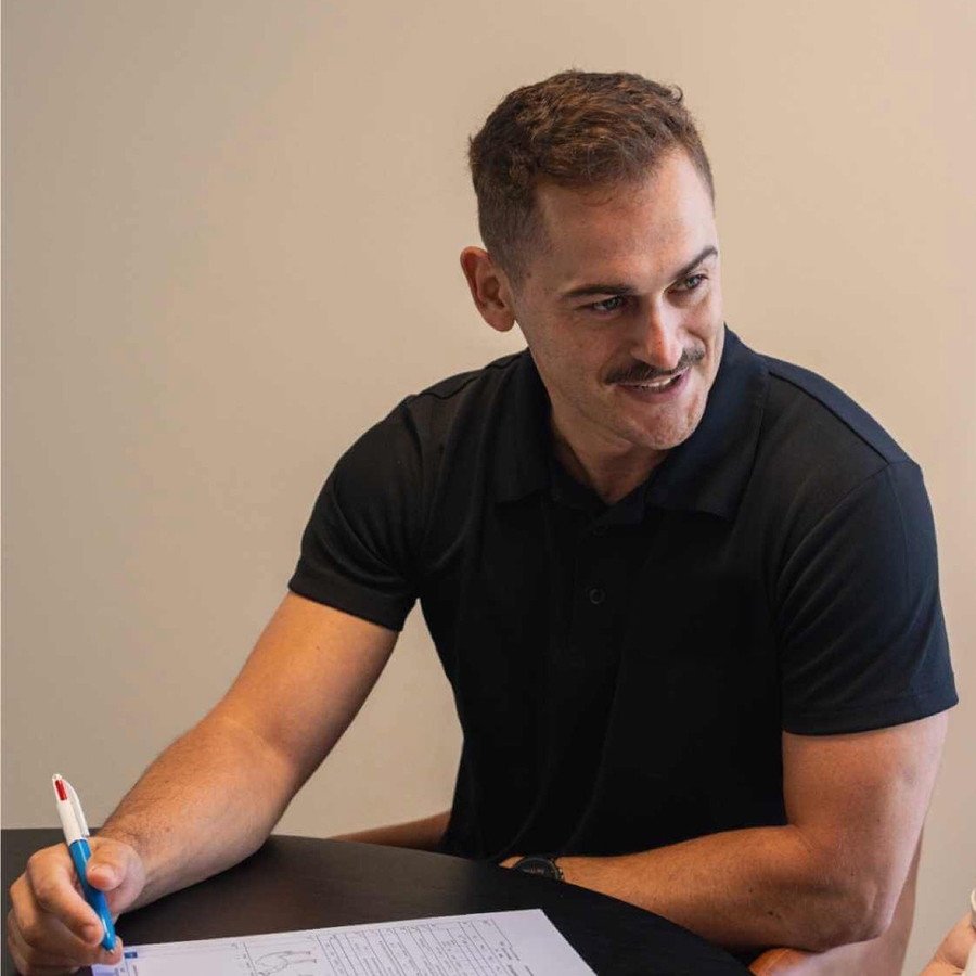 Simon, occupational therapist at Mallee Occupational Therapy, completing an assessment form with a client